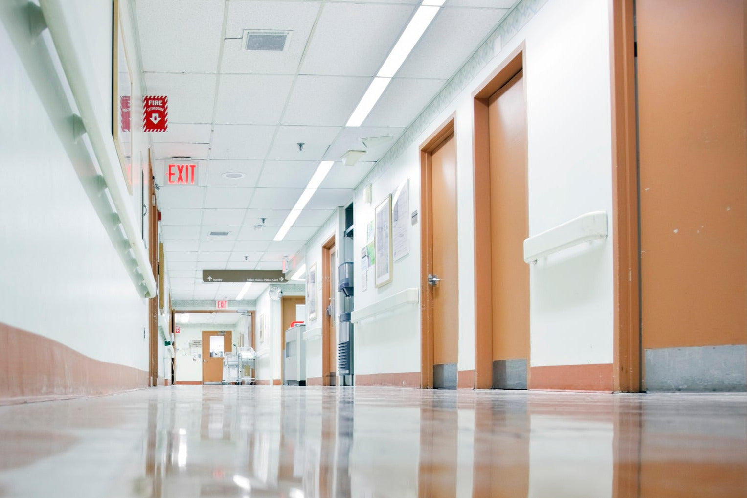Shiny hospital hallway floor posing slip risk – ideal for Stellmann Non-Slip Clear coating in healthcare compliance and patient safety