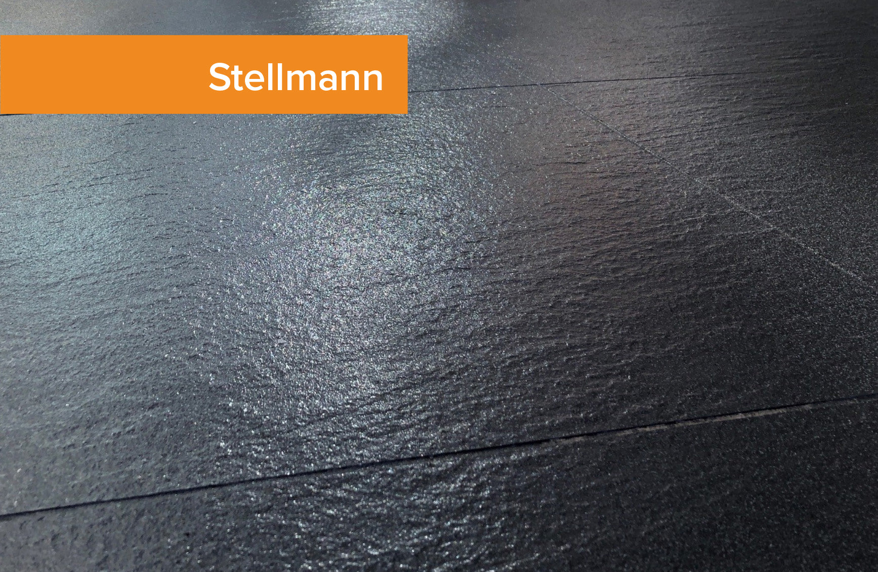 Stellmann clear non-slip coating on black tile – smooth, sealed, and certified safe without surface damage