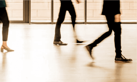 P4 vs P5 Slip Rating: What Each Means for Your Building - people walking on non-slip floor coating in a public space.
