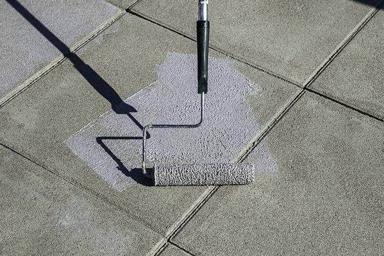 What Is The Best DIY Anti-Slip Coating for Homeowners? Applying clear non-slip coating for tiles on outdoor surface.