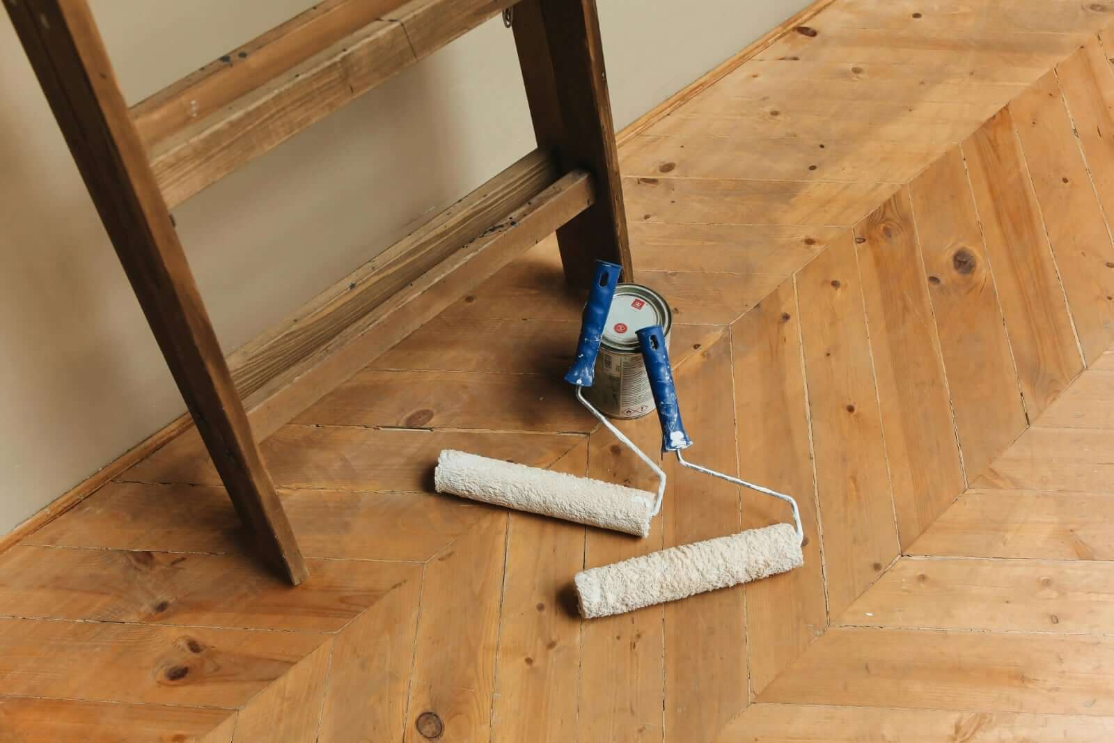 Floor Paint with Grit: How It Works, Common Problems, and a Better Alternative - paint rollers on wooden flooring