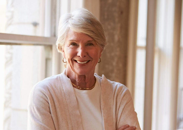 Slipping risks: “I was walking on thin ice in my bathroom” - elderly woman smiling in a well-lit home.