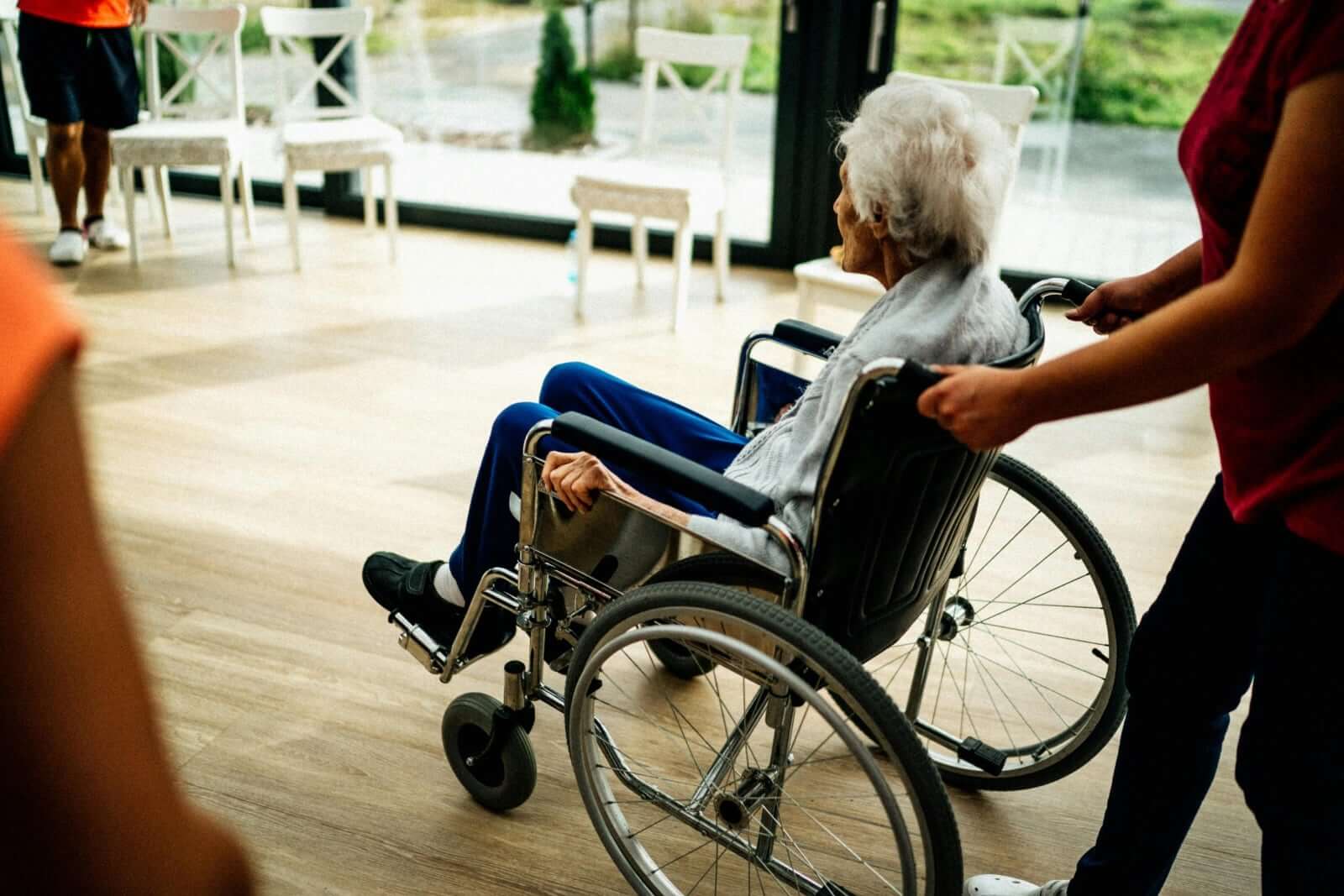 P3 vs P4 Slip Ratings For Aged Care: Which is Better? elderly woman in wheelchair in aged care facility