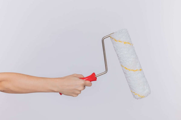 Non-Invasive NDIS Home Modifications to Explore in 2026: DIY non-slip floor kit installation with paint roller.
