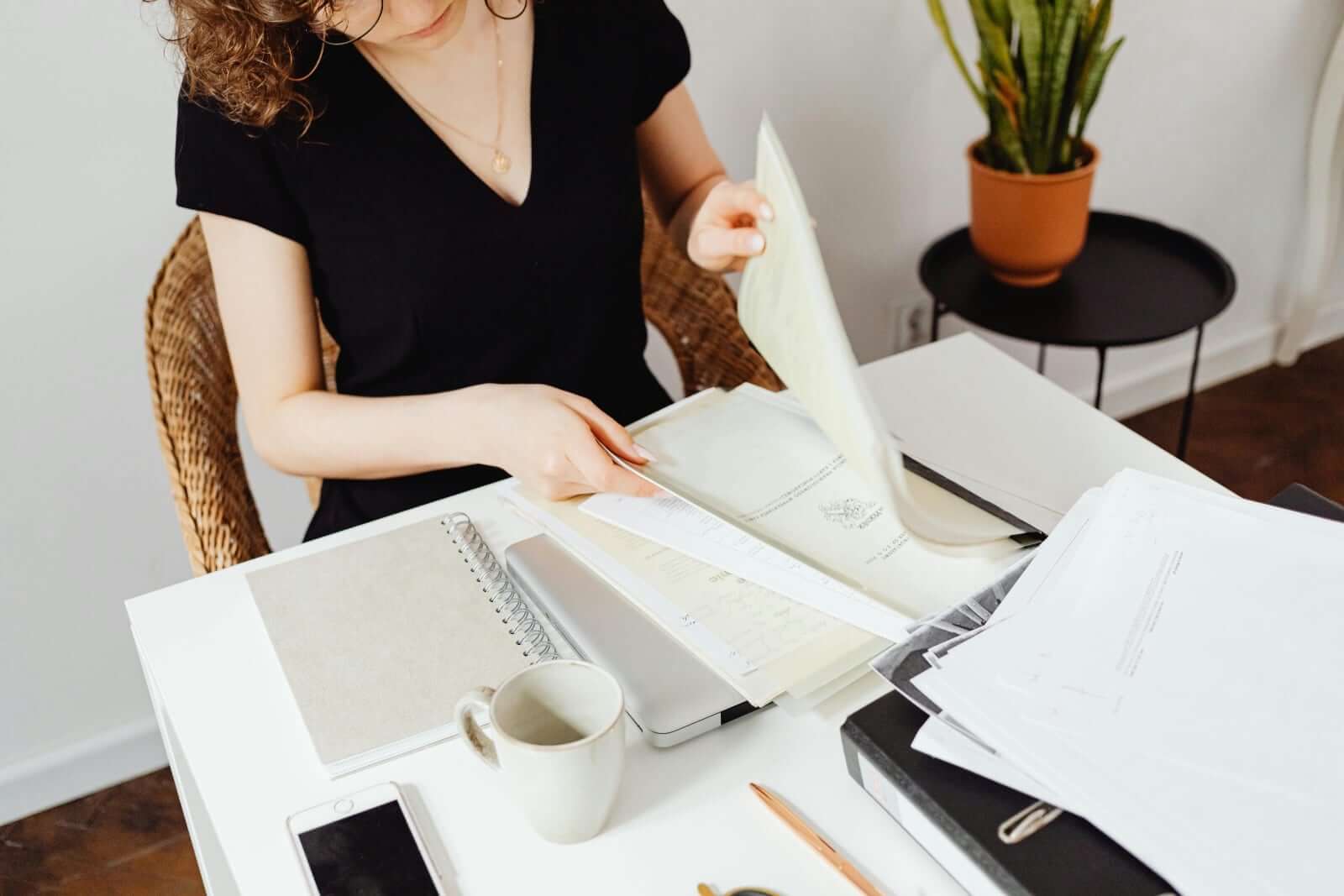 NDIS Home Modifications in 2026: What’s Funded and How to Get Approved, woman reviewing documents on a desk