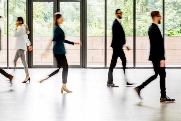 People walking on a non-slip floor, showcasing Stellmann scores outstanding results in accelerated wear test.