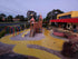 Outdoor childcare play area with bright yellow Stellmann anti-slip coating, enhancing safety and visual direction for kids and carers