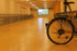 Bright yellow Stellmann non-slip coating applied to indoor bicycle parking zone, enhancing safety and visibility