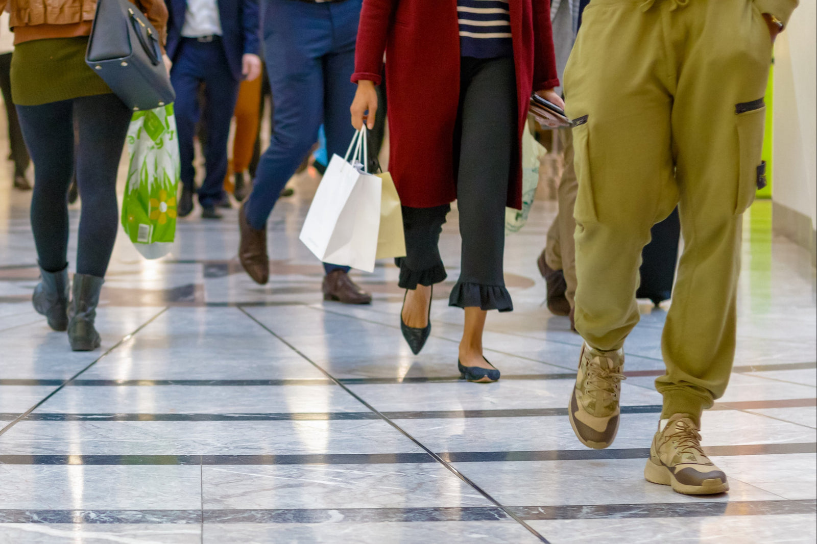 Retail shopping center entry with slip-resistant tile coating and foot traffic