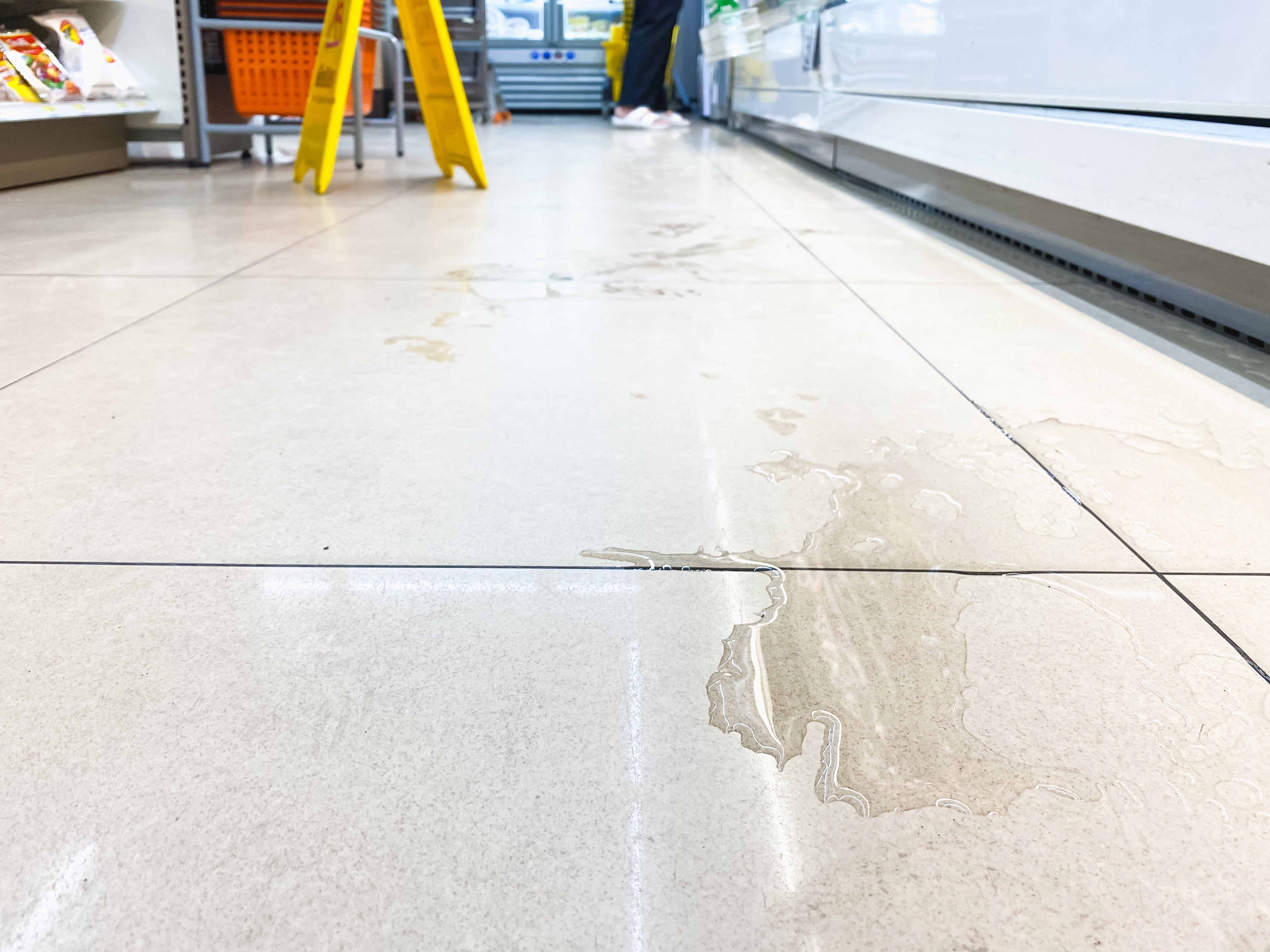 Wet grocery floor before anti-slip coating application